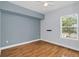 Simple bedroom with hardwood floors and a window at 204 E South St # 1055, Orlando, FL 32801