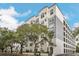Three-story building with a modern design and lush landscaping at 204 E South St # 1055, Orlando, FL 32801
