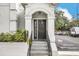 Building entryway with black door and grey stone steps at 204 E South St # 1055, Orlando, FL 32801