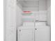Laundry room with washer and dryer and overhead shelving at 204 E South St # 1055, Orlando, FL 32801