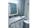 Updated bathroom with granite countertop and white cabinetry at 218 Meadow Green Dr, Davenport, FL 33837
