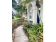 Landscaped front yard with walkway and lush tropical plants at 218 Meadow Green Dr, Davenport, FL 33837