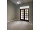 Bright bedroom with carpeting and French doors leading to patio at 218 Meadow Green Dr, Davenport, FL 33837
