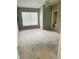 Spacious bedroom with neutral carpeting and large window at 218 Meadow Green Dr, Davenport, FL 33837