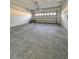 Unfinished two-car garage with concrete flooring at 2936 Sharp Rd, Kissimmee, FL 34744