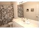 Clean bathroom with floral shower curtain and vanity at 3128 Sun Lake Ct # A, Kissimmee, FL 34747