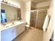 Bathroom with white vanity, shower, and tiled floor at 3128 Sun Lake Ct # A, Kissimmee, FL 34747