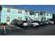 Light teal condo building with ample parking and landscaping at 3128 Sun Lake Ct # A, Kissimmee, FL 34747