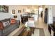 Open living room with a grey sofa, coffee table, and adjacent dining area at 3128 Sun Lake Ct # A, Kissimmee, FL 34747