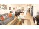 Open living room with a grey sofa, coffee table, and adjacent dining area at 3128 Sun Lake Ct # A, Kissimmee, FL 34747