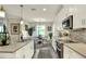 Open concept kitchen boasting white cabinets, a center island, and stylish backsplash at 4002 Bedford Ave, Winter Haven, FL 33884