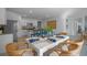Open concept dining area with white table and kitchen view at 4185 Singing Mockingbird Blvd, Bartow, FL 33830