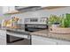 Modern kitchen with stainless steel appliances and granite countertops at 4185 Singing Mockingbird Blvd, Bartow, FL 33830