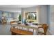 Bright dining area with white table, bench, and wicker chairs, offering a casual, coastal feel at 4185 Singing Mockingbird Blvd, Bartow, FL 33830