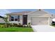 Single story home with neutral exterior, two car garage, and landscaping at 4185 Singing Mockingbird Blvd, Bartow, FL 33830