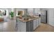 Kitchen island with granite countertop and stainless steel dishwasher at 4185 Singing Mockingbird Blvd, Bartow, FL 33830