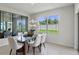 Modern dining room with glass table and view to backyard at 4189 Singing Mockingbird Blvd, Bartow, FL 33830