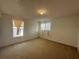 Bright bedroom with carpet flooring and two windows at 4458 Philadelphia Cir, Kissimmee, FL 34746