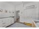 Bedroom featuring a crib, dresser, and access to a bathroom at 6807 Sylvan Woods Dr, Sanford, FL 32771