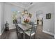 Spacious dining area with a large farmhouse table, view of kitchen at 6807 Sylvan Woods Dr, Sanford, FL 32771