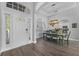 Bright dining room features a farmhouse table and chandelier, adjacent to the kitchen at 6807 Sylvan Woods Dr, Sanford, FL 32771