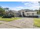 Well-maintained house featuring a brick paver driveway and lush landscaping at 6807 Sylvan Woods Dr, Sanford, FL 32771