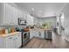 Open concept kitchen with stainless steel appliances, white cabinets, and an island at 6807 Sylvan Woods Dr, Sanford, FL 32771