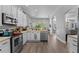 Modern kitchen with stainless steel appliances, white cabinets, and breakfast bar at 6807 Sylvan Woods Dr, Sanford, FL 32771