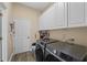 Laundry room with washer, dryer, cabinets, and extra storage at 6807 Sylvan Woods Dr, Sanford, FL 32771