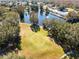 Aerial view of a putting green next to a lake at 711 Polo Park Blvd, Davenport, FL 33897