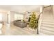 Living room with Christmas tree, sectional sofa, and view of staircase at 7224 Enchanted Lake Dr, Winter Garden, FL 34787