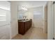 Bathroom with double vanity and granite countertop at 14613 Erice Ave, Clermont, FL 34714