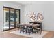 Modern dining room with a wooden table and black chairs, near sliding doors at 1948 Rowena Ave, Orlando, FL 32803