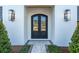 Elegant double front doors with a black finish and a stone walkway at 1948 Rowena Ave, Orlando, FL 32803