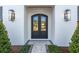 Modern front entrance with a black double door and stylish light fixtures at 1948 Rowena Ave, Orlando, FL 32803