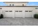 Three-car garage with white doors and a paved driveway at 1948 Rowena Ave, Orlando, FL 32803