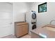 Laundry room with stacked washer and dryer, plus a sink at 1948 Rowena Ave, Orlando, FL 32803