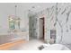 Spa-like bathroom with marble, a large walk-in shower, and double vanity at 1948 Rowena Ave, Orlando, FL 32803