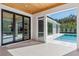 Covered patio overlooking a refreshing pool and grassy backyard at 1948 Rowena Ave, Orlando, FL 32803