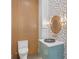 Stylish powder room with wood wall, patterned tile, and vessel sink at 1948 Rowena Ave, Orlando, FL 32803