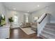 Open living room with L-shaped sectional sofa and hardwood floors at 2108 Lobelia Dr, Lake Mary, FL 32746