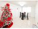 Festive dining room with a glass table and Christmas tree at 2109 Morning Dr, Orlando, FL 32809