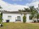 White single-story house with a swing and nicely landscaped lawn at 2109 Morning Dr, Orlando, FL 32809