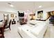 Spacious living room with white sectional sofa and a fireplace at 2109 Morning Dr, Orlando, FL 32809