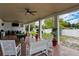 Covered patio with pool table, seating, and ceiling fans at 2109 Morning Dr, Orlando, FL 32809