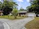 House exterior showcasing a split driveway and mature trees at 2225 Cindy Cir, Orlando, FL 32818