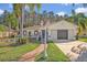 House exterior featuring a landscaped yard, walkway, and two-car garage at 2460 Oak Mill Dr, Kissimmee, FL 34744
