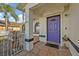 Purple front door entrance with tiled flooring and iron railing at 2460 Oak Mill Dr, Kissimmee, FL 34744