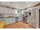 Modern kitchen with stainless steel appliances and light teal cabinets at 2460 Oak Mill Dr, Kissimmee, FL 34744