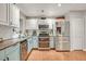 Modern kitchen with stainless steel appliances and teal cabinets at 2460 Oak Mill Dr, Kissimmee, FL 34744